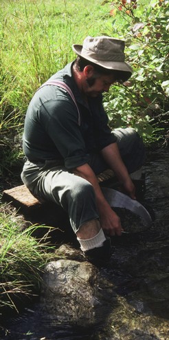 Figure 18. The thrill of the chase: Dave Pighin, a characteristically restless frontier exploration geologist, panning for gold in the mountains of British Columbia.